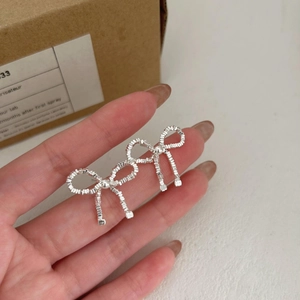 S925 sterling silver bow knot stud earrings with a textured silver sand finish for women