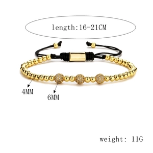 Detail of adjustable black woven bracelet with golden beads and micro-set zircon spheres