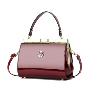 Elegant burgundy patent leather handbag with vintage metal frame and detachable strap
