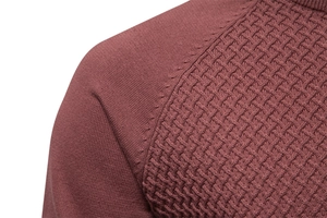 Detail of burgundy cotton sweater showing raglan sleeve stitch and waffle knit texture