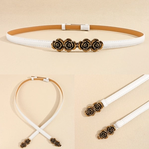 Detail of adjustable white leather belt with vintage golden rose metal flower buckles