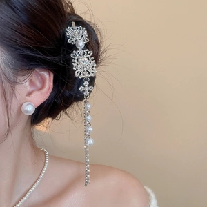 Detail of square rhinestone hair clip with pearl tassels on model in vintage style