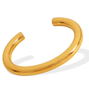 Polished gold C-shape thick metal bangle with a minimalist open design and shiny finish