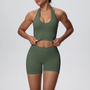 Detailed knit texture of olive green ribbed high-waist yoga shorts and halter bra