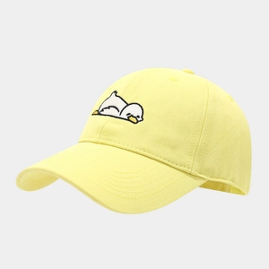 Detail of cute white duck embroidery on soft yellow twill cotton baseball cap