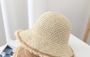 Detalle macro del tejido de paja y el borde deshilachado de este sombrero de verano