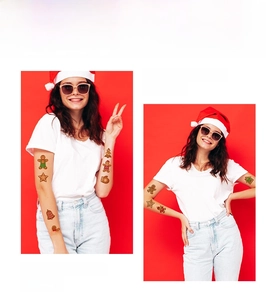 Detailed view of gingerbread man and Christmas tree tattoos on a model arm
