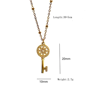 Detailed view of gold key pendant necklace with dimensions 20x10mm and micro-inlaid diamonds