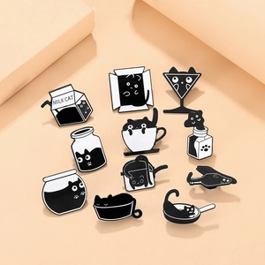 Detailed set of 11 cute black and white enamel cat pins in various containers and boxes