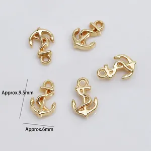 Macro view of gold plated anchor charms for DIY nail art and jewelry making