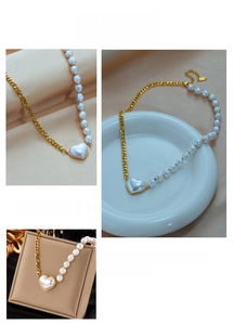 Detailed view of asymmetric heart pearl necklace with gold plated curb chain and lobster clasp