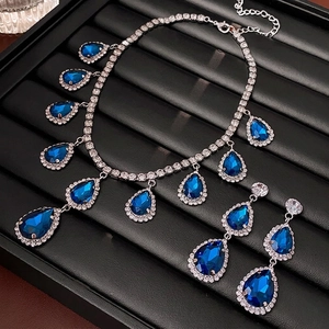 Silver needle drop earrings and necklace set with blue pear-cut crystals and diamonds