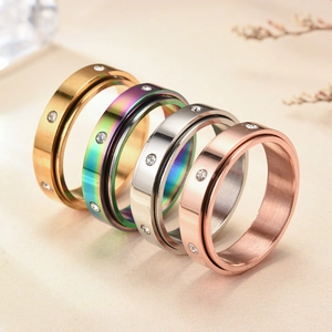 Rotating stainless steel rings with sparkling cubic zirconia in four metallic colors