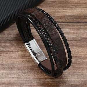 Macro view of multi-layer leather braid and silver magnetic buckle on a male bracelet