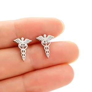 Macro detail of silver medical caduceus earrings made of polished stainless steel