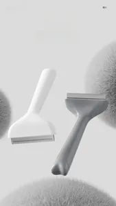 T-shaped pet hair combs in white and grey for effective deshedding and undercoat removal