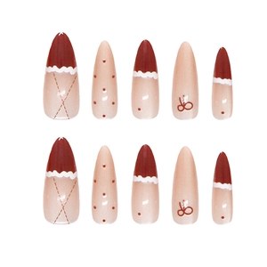 Handmade burgundy and nude pink stiletto press-on nails with French dots and bows