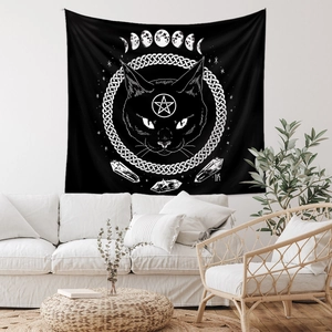 Close-up of cat head and lunar phase tapestry displayed in a cozy living room setup