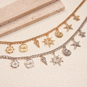 Detail view of gold and silver shell and starfish charms on metallic summer chains