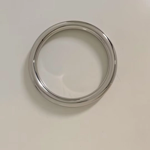Polished silver stainless steel hollow bangle with minimalist rounded reflective surface