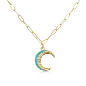 Close-up of 18K gold plated necklace with moon pendant featuring blue enamel and cubic zirconia