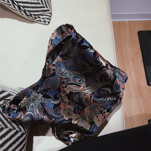 Detail of retro floral jacquard pattern on a black Chinese style underarm bag