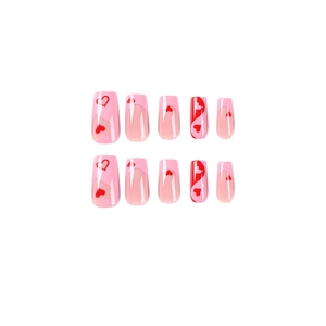 Pink French tip press-on nails with red heart patterns in medium trapezoid shape