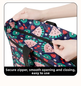 Detail showing smooth zipper closure on large insulated tote bag with fruit pattern