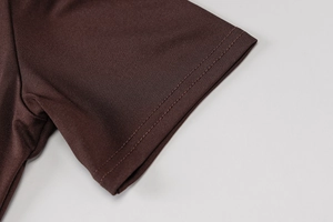 Detail of coffee brown yoga jumpsuit sleeve featuring premium double-stitch seams