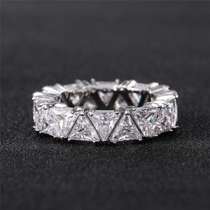 Macro shot of eternity ring with triangle cut cubic zirconia stones in silver setting