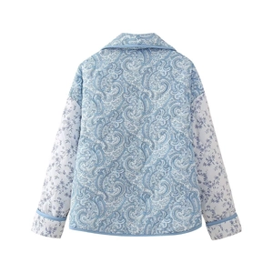 Back view of a blue floral paisley quilted jacket with contrast binding and collared neck