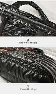 Detail view of smooth metal zipper and even stitching on black quilted nylon tote bag