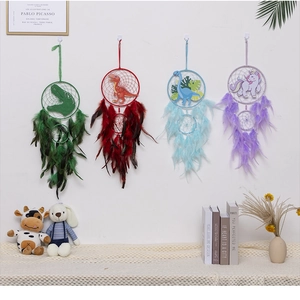 Detail of four dinosaur and unicorn dream catchers with colorful feathers hanging on a wall