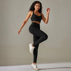 Close-up of black seamless yoga set showing high-elastic knit fabric and racerback detail