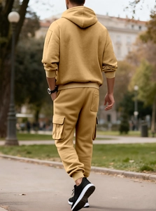 Outdoor shot of men's mustard yellow hooded tracksuit with cargo jogger pants details