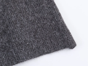 Close-up of premium dark grey knit fabric texture with soft cashmere-like finish