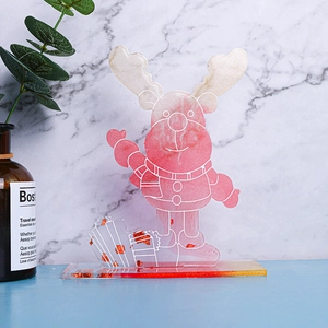 Close-up of pink glitter Christmas reindeer figurine with gold foil and resin details