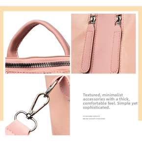 Close-up of pink leather backpack handles, metal zippers, and strap connection hooks