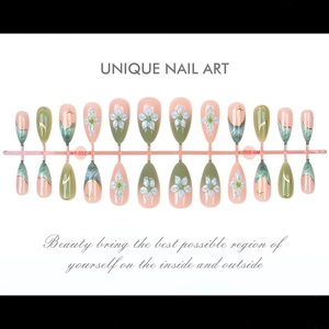 Detailed set of emerald green gradient press-on nails with 3D white flowers and gold stars