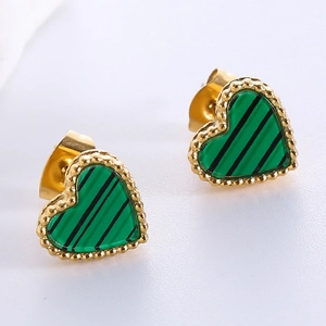 Macro shot of heart-shaped gold stud earrings with green malachite-patterned inlay