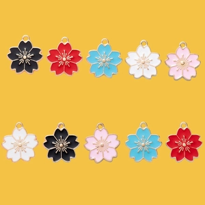 Colorful sakura alloy pendants for DIY jewelry making in five assorted shades on yellow