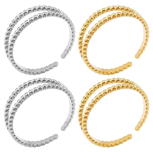 Macro view of gold and silver beaded open rings featuring double row perlée style design