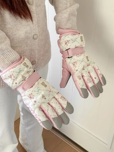 Detail of waterproof ski gloves featuring cute bear prints and adjustable wrist straps