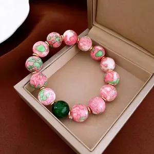 Retro beaded ceramic bracelet with gold-plated spacers and pink floral patterns