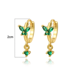 Detailed view of gold butterfly earrings with green zircons showing a 2cm height measurement