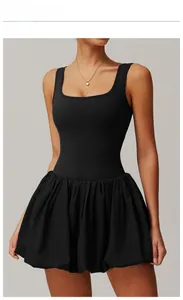 Close-up of black sleeveless tennis dress featuring a square neck and pleated bubble hem