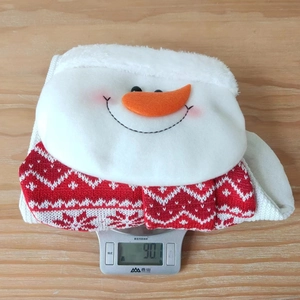 Detail showing a snowman Christmas stocking weight of 90.1g on an electronic scale