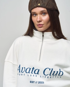 Close-up of the white quarter-zip sweatshirt featuring blue Avata Club graphic text