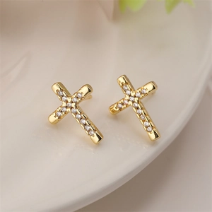 Detailed close-up of gold-plated cross stud earrings featuring clear zircon stone accents