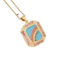Octagon 18K gold necklace with pink gems and blue enamel rainbow pendant on white background